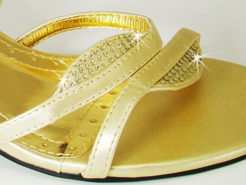 Gold sandal with rhinestone details on a white background