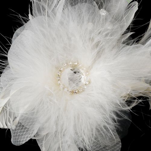 White feathered headpiece with decorative center on a black background